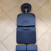 Two black pillows on a tiled floor