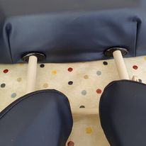 Pair of blue shoes with white soles on a polka dot surface